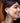 Side view picture of Francoise gold long statement earrings in turquoise and blue worn by a model. Zijaanzichtfoto van lange grote gouden oorbellen genaamd Francoise in de kleuren turquoise en blauw gedragen door een model.
