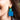 Close-up picture of square turquoise and petrol blue Esmee statement earrings worn on model. Close-up foto van grote vierkante turquoise en petrol blauwe Esmee oorbellen gedragen door een model.