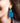 Close-up picture of square turquoise and petrol blue Esmee statement earrings worn on model. Close-up foto van grote vierkante turquoise en petrol blauwe Esmee oorbellen gedragen door een model.