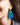 Close-up picture of square turquoise and petrol blue Esmee statement earrings worn on model. Close-up foto van grote vierkante turquoise en petrol blauwe Esmee oorbellen gedragen door een model.