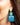 Close-up picture of square turquoise and petrol blue Esmee statement earrings worn on model. Close-up foto van grote vierkante turquoise en petrol blauwe Esmee oorbellen gedragen door een model.