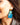 Close-up picture of square turquoise and petrol blue Esmee statement earrings worn on model. Close-up foto van grote vierkante turquoise en petrol blauwe Esmee oorbellen gedragen door een model.