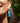Close-up picture of turquoise gold Anna earrings worn on a model. Close-up foto van turquoise gouden Anna oorbellen gedragen door een model.